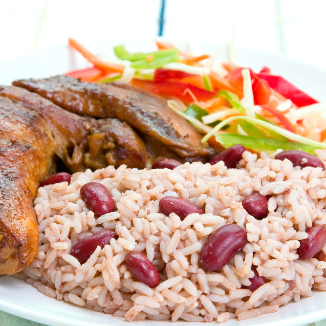 A nicely plated Jamaican cuisine. Jerk chicken, rice and peas, and a side salad.